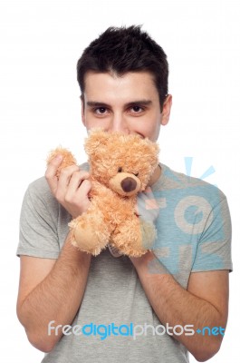 Man Cuddling Teddy Bear Stock Photo