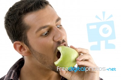 Man Eating Green Apple Stock Photo