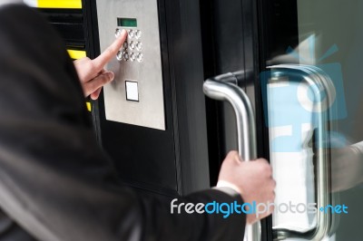 Man Entering Security Code To Unlock The Door Stock Photo