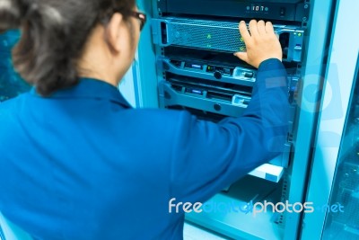 Man Fix Server Network In Data Center Room Stock Photo