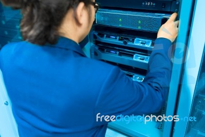 Man Fix Server Network In Data Center Room Stock Photo