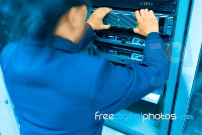 Man Fix Server Network In Data Center Room Stock Photo