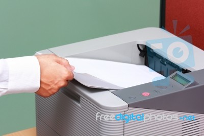 Man Fixing Paper Into Printerc Stock Photo