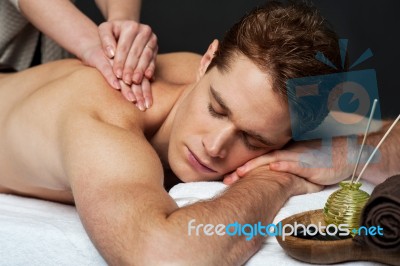 Man Getting Relaxing Massage In Spa Stock Photo