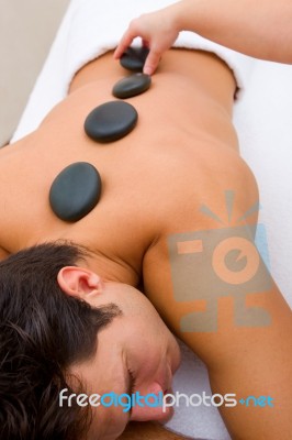 Man Having Hot Stone Massage Stock Photo