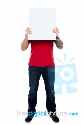 Man Hiding Face With Blank Board Stock Photo