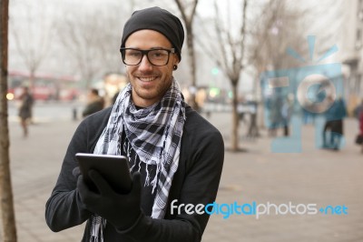 Man Holdin I-pad Tablet Computer On Street Stock Photo