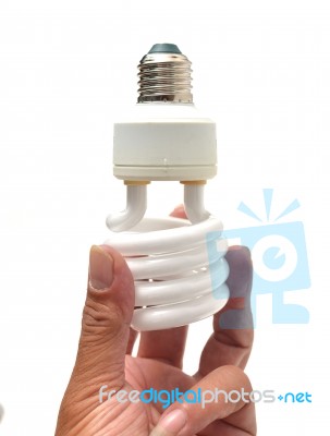 Man Holding A Light Bulb On A White Background Stock Photo