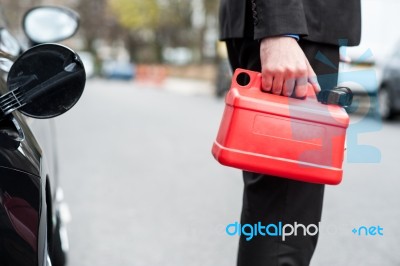 Man Holding Fuel Can, Cropped Image Stock Photo