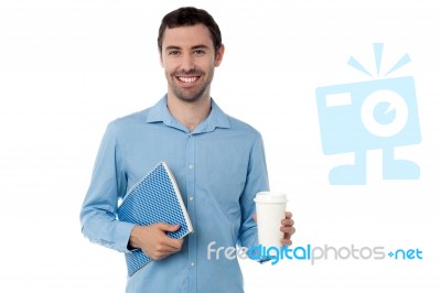 Man Holding Notebook And Beverage Stock Photo