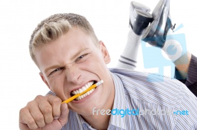 Man Holding Pencil With Teeth Stock Photo