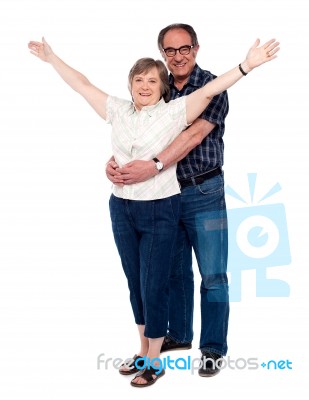 Man Hugging His Wife From Behind Stock Photo