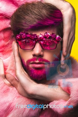 Man In A Pink Fur Coat And Carnival Glasses Stock Photo