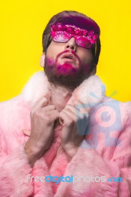 Man In A Pink Fur Coat And Carnival Glasses Stock Photo