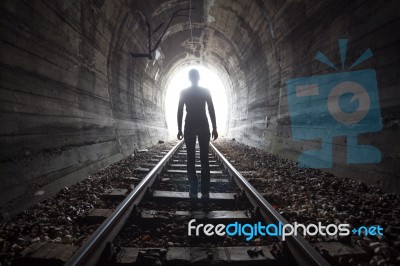 Man In A Tunnel Looking Towards The Light Stock Photo