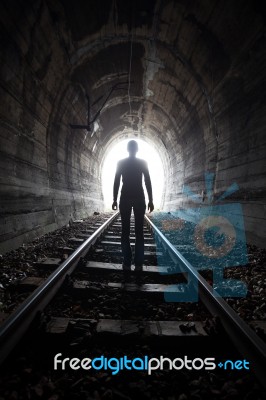 Man In A Tunnel Looking Towards The Light Stock Photo