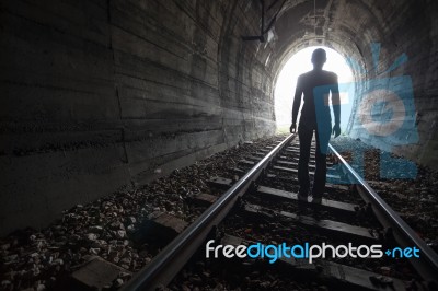 Man In A Tunnel Looking Towards The Light Stock Photo