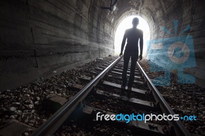 Man In A Tunnel Looking Towards The Light Stock Photo