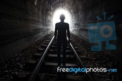 Man In A Tunnel Looking Towards The Light Stock Photo