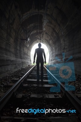 Man In A Tunnel Looking Towards The Light Stock Photo