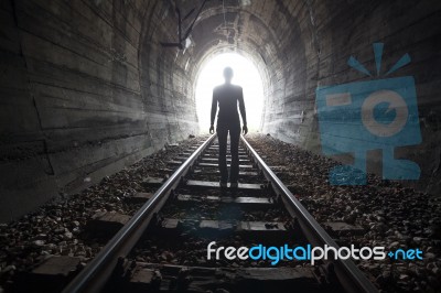 Man In A Tunnel Looking Towards The Light Stock Photo