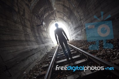 Man In A Tunnel Looking Towards The Light Stock Photo