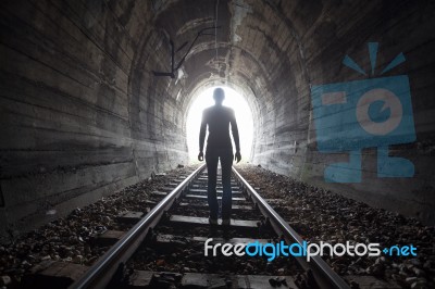 Man In A Tunnel Looking Towards The Light Stock Photo