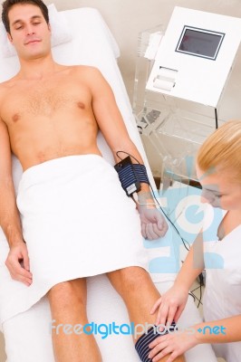 Man In Beauty Center Having Muscle Mass Check Stock Photo