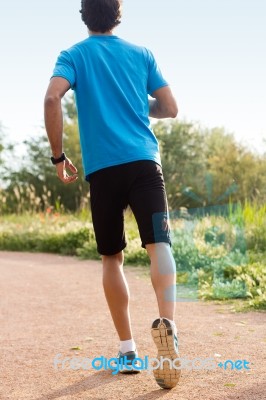 Man In Sportswear Running In A Park Stock Photo