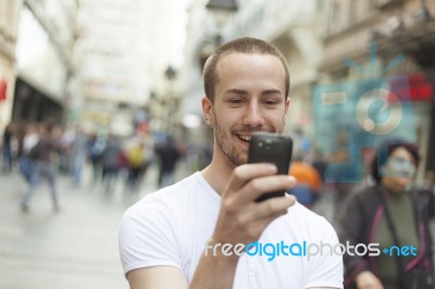 Man In Street With Cell Phone Stock Photo