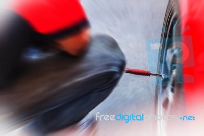 Man Inflate Tires In The Garage Stock Photo