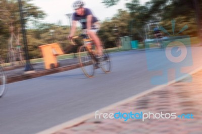 Man Is Cycling In Park Stock Photo