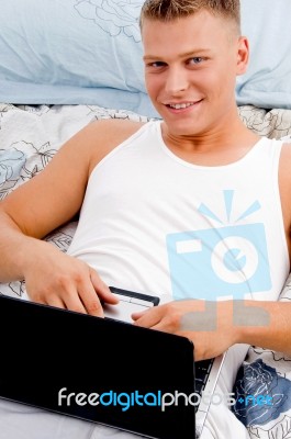 Man Keeping Laptop On His Stomach Stock Photo