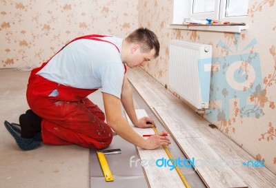 Man Laying Laminate Flooring Stock Photo