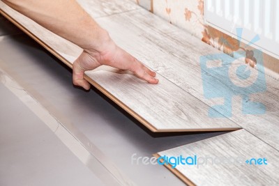 Man Laying Laminate Flooring Stock Photo