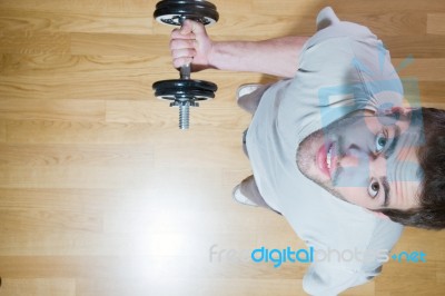 Man Lifting Dumbbell In Gym Stock Photo