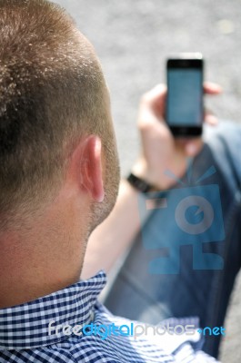 Man Looking At Smartphone Stock Photo