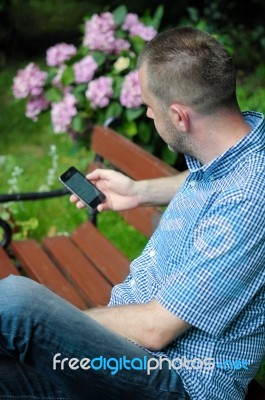 Man Looking At Smartphone Stock Photo