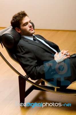 Man Lying On Chaise Longue Stock Photo