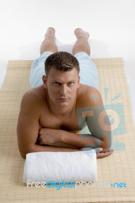 Man Lying On Mat For Spa Treatment Stock Photo