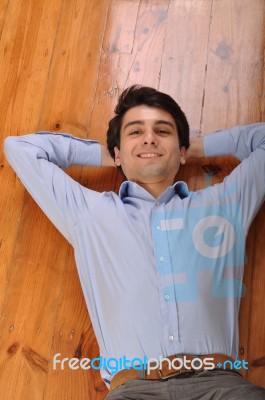 Man Lying On The Floor Stock Photo