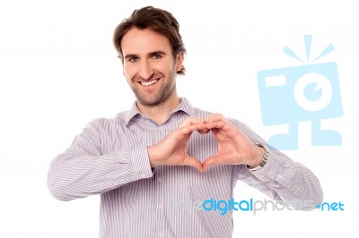 Man Making Heart Symbol With Hands Stock Photo