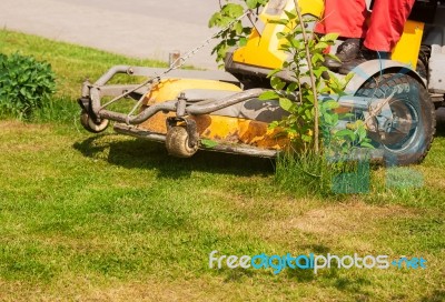 Man Mows A Lawn Mower Stock Photo