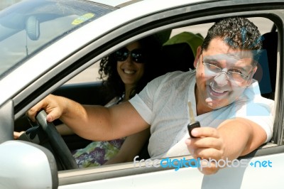 Man Offering Keys Stock Photo