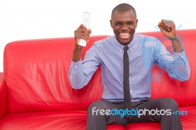 Man On The Sofa With Remote Control Rejoices Stock Photo