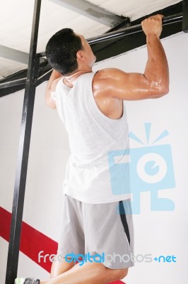 Man Performing Pull Ups In A Bar Stock Photo