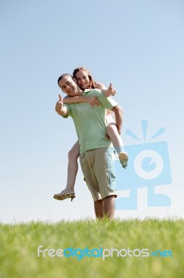 Man Piggybacking His Girlfriend Stock Photo