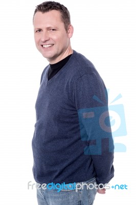 Man Posing With Hands Behind His Back Stock Photo