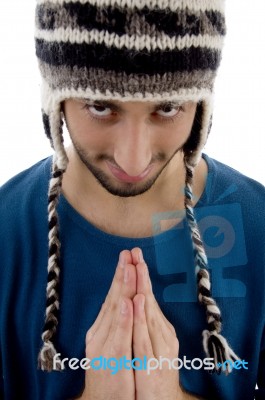 Man Praying With Woollen Cap Stock Photo