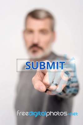 Man Pressing Virtual Submit Button Stock Photo